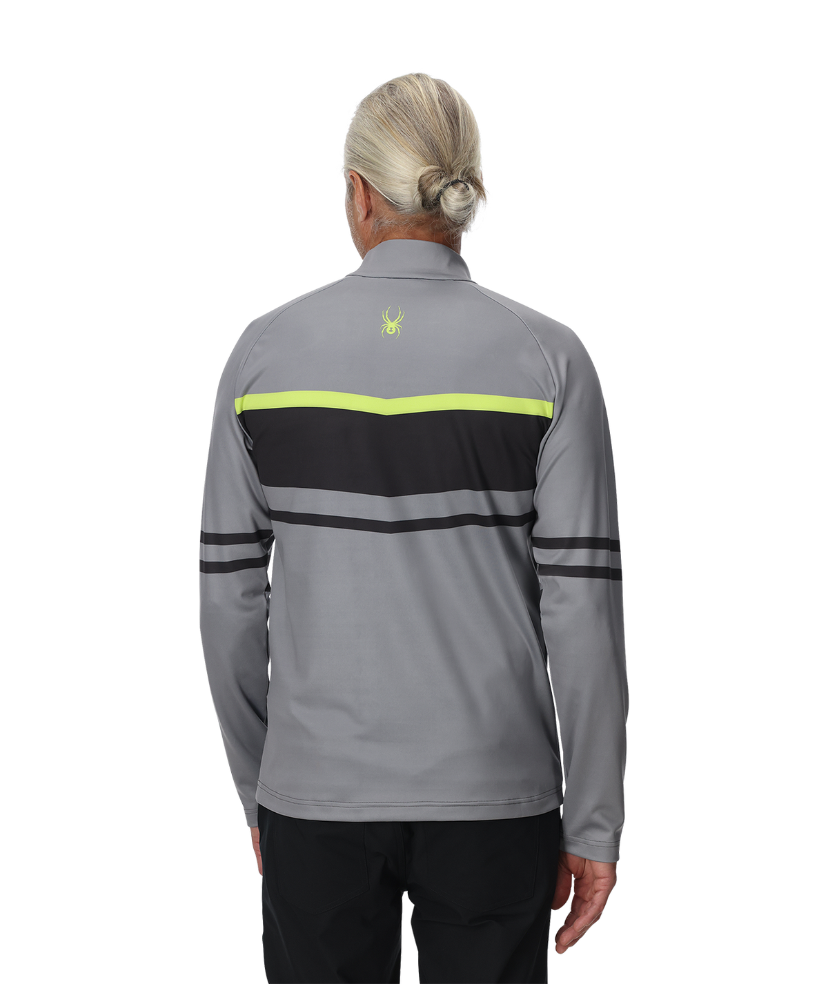 Person wearing a gray and black jacket with a logo on the back, on a white background