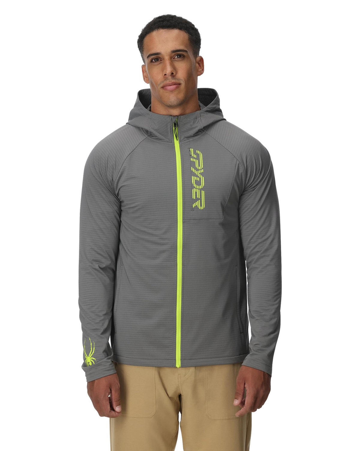 Man wearing a gray jacket with a green zipper and 'Spyder' branding on a white background