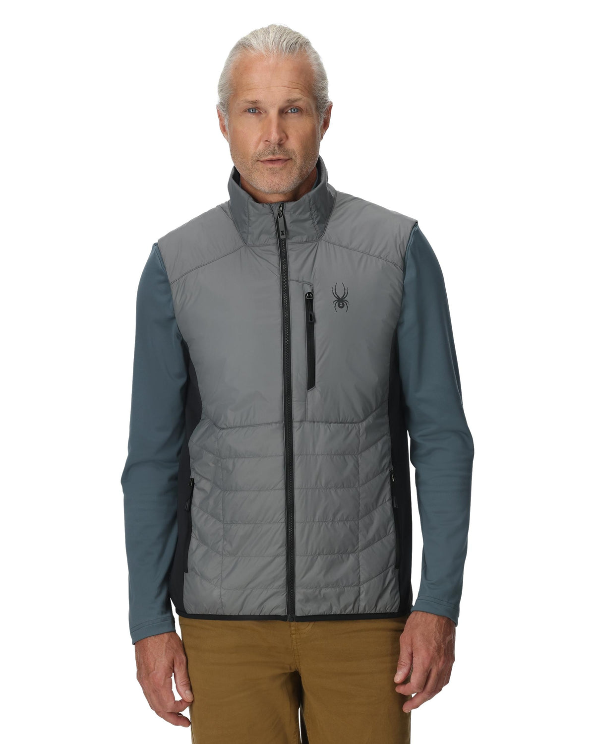 Man wearing a gray and blue vest with a brand logo on a white background