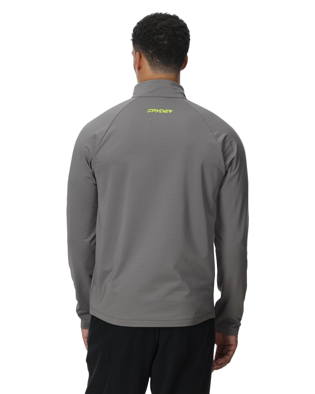 Person wearing a gray long-sleeve shirt with a brand logo on the back against a white background