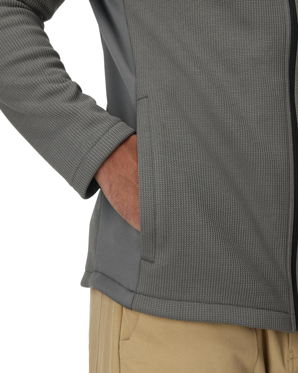 Close-up of a gray textured jacket with a person wearing it, focusing on the sleeve and chest area.