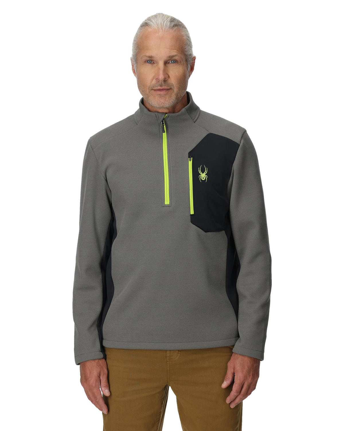 Man wearing a gray and black pullover with a logo on a white background