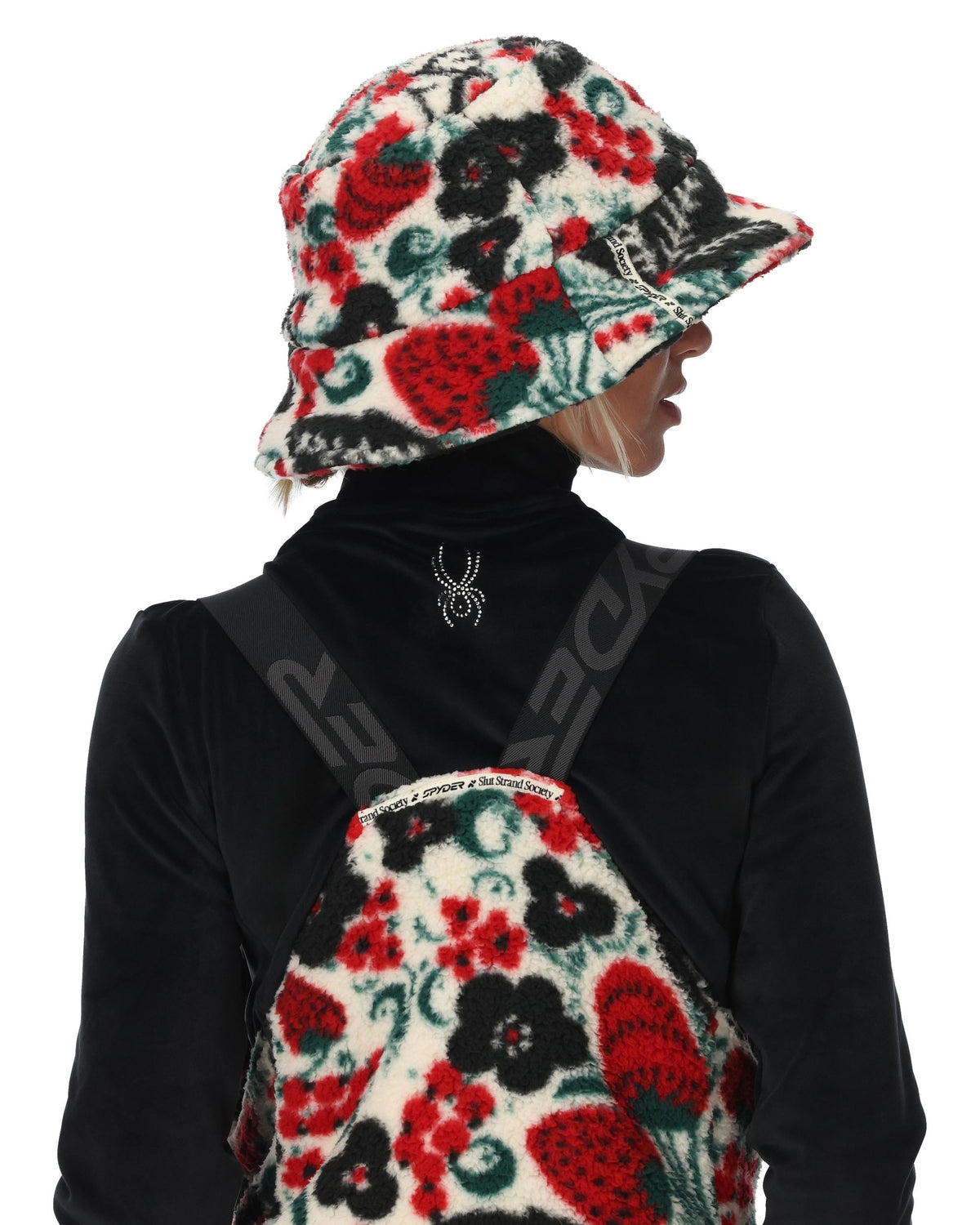 Person wearing a floral bucket hat and matching floral bag on a white background