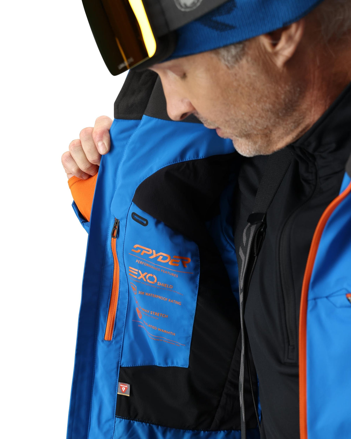 Person wearing a blue and black jacket with Spyder branding