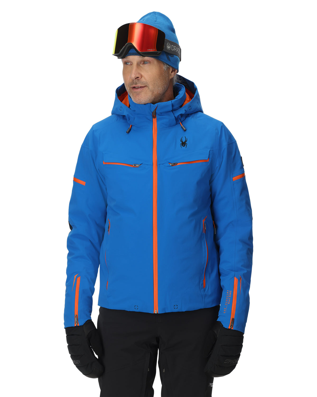 Person wearing a blue ski jacket with orange accents on a white background