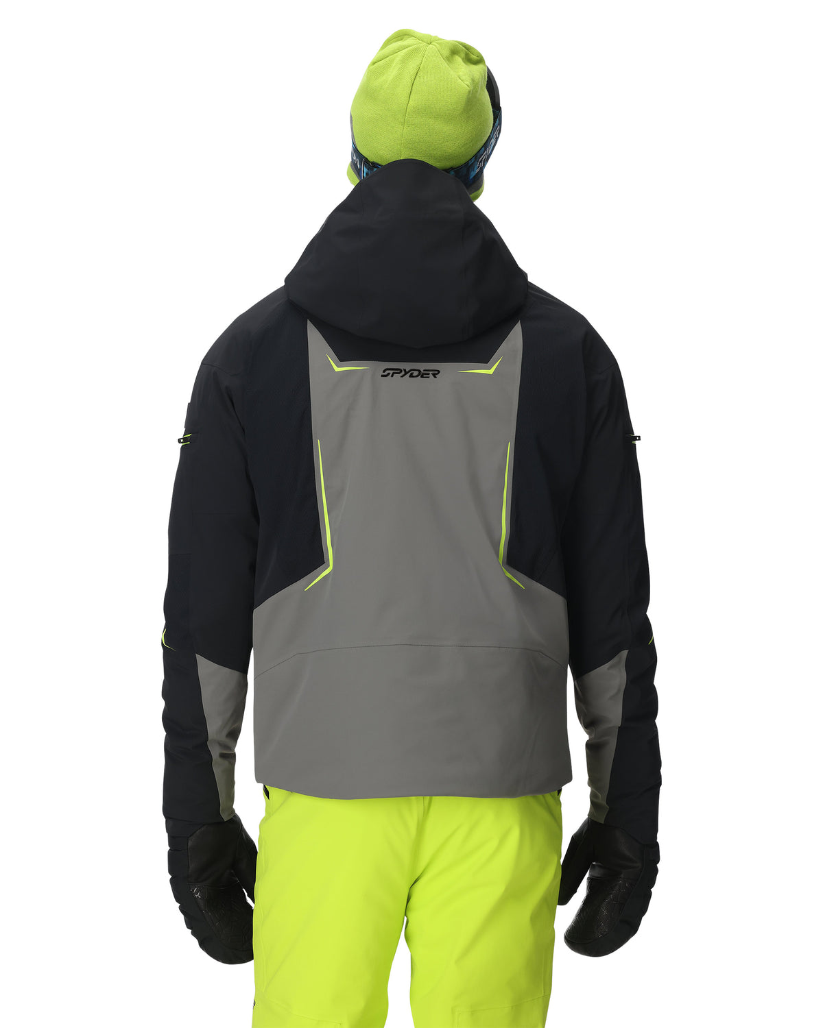 Person wearing a black and gray jacket with green accents on a white background