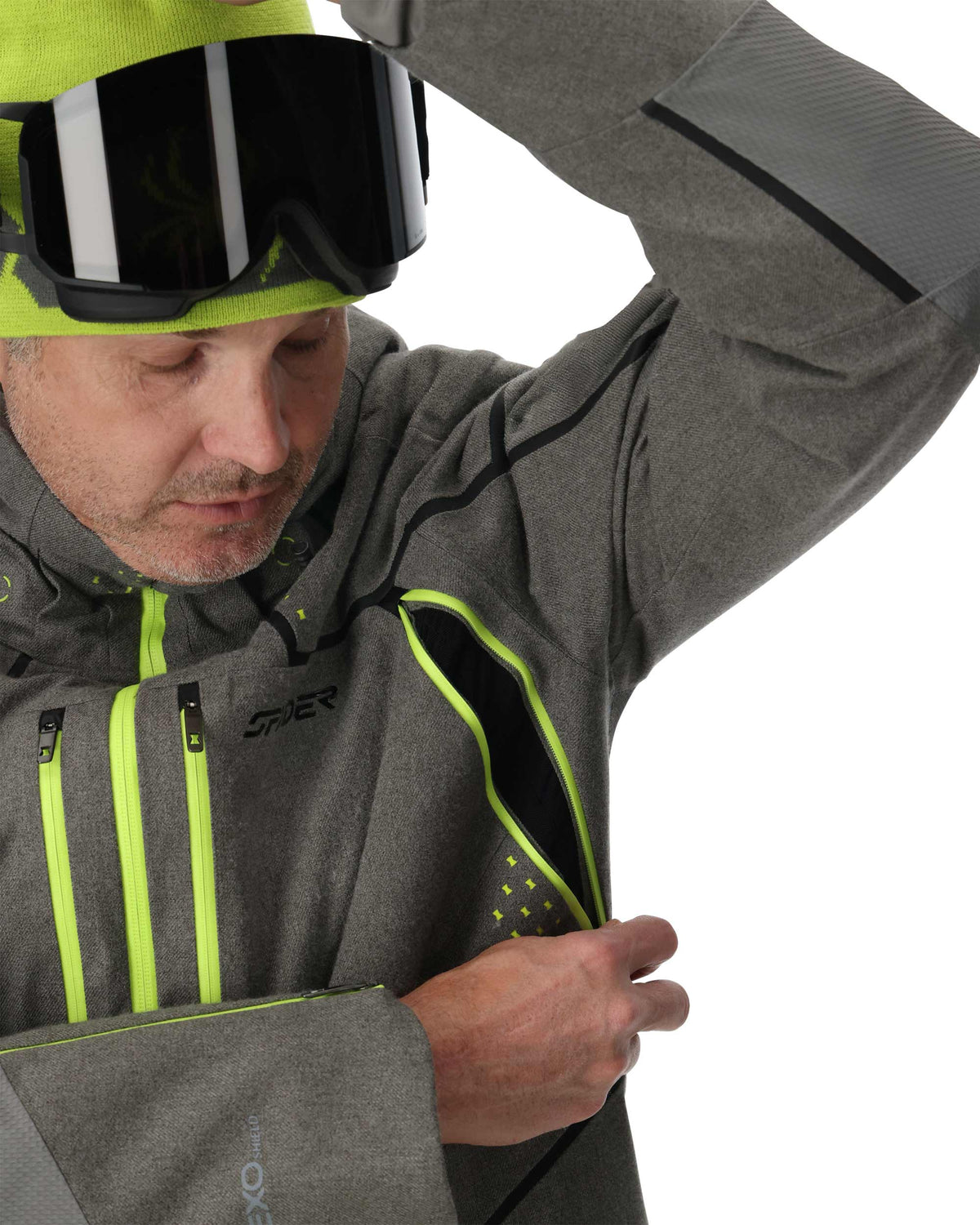 Person wearing a gray jacket with green accents and a helmet, on a white background