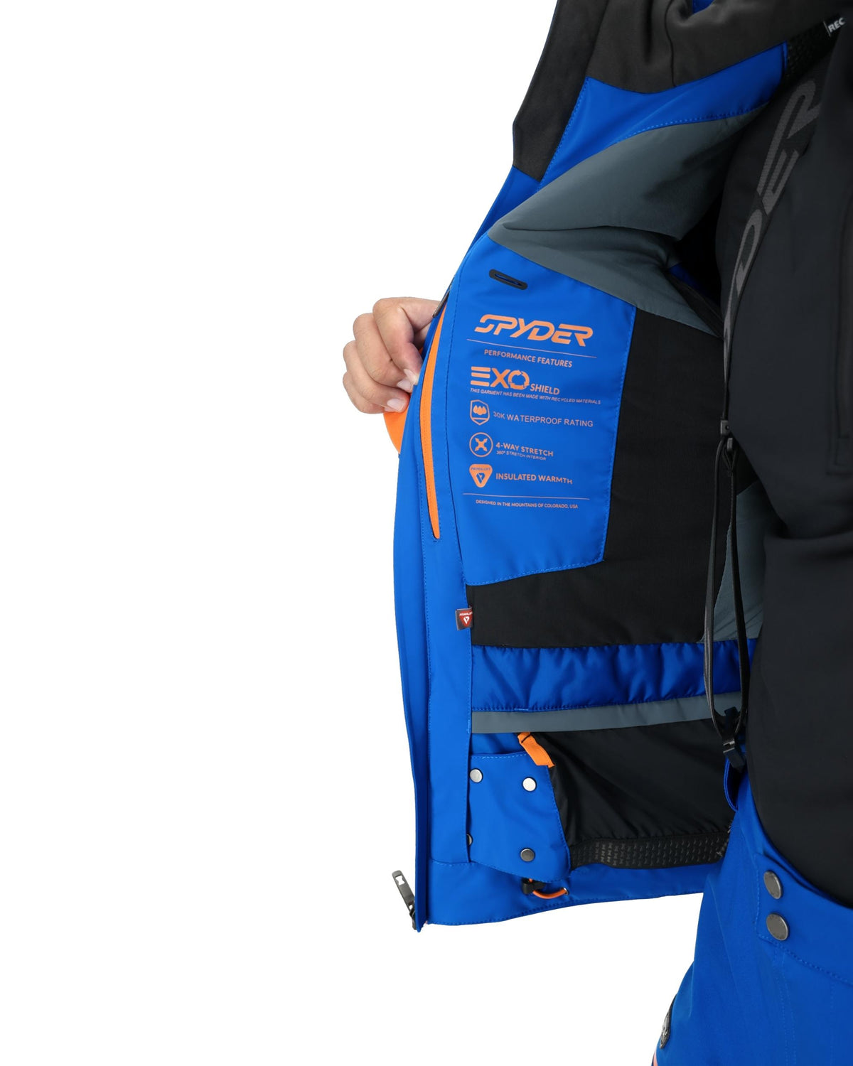 Blue and black Spyder jacket with visible branding on a white background