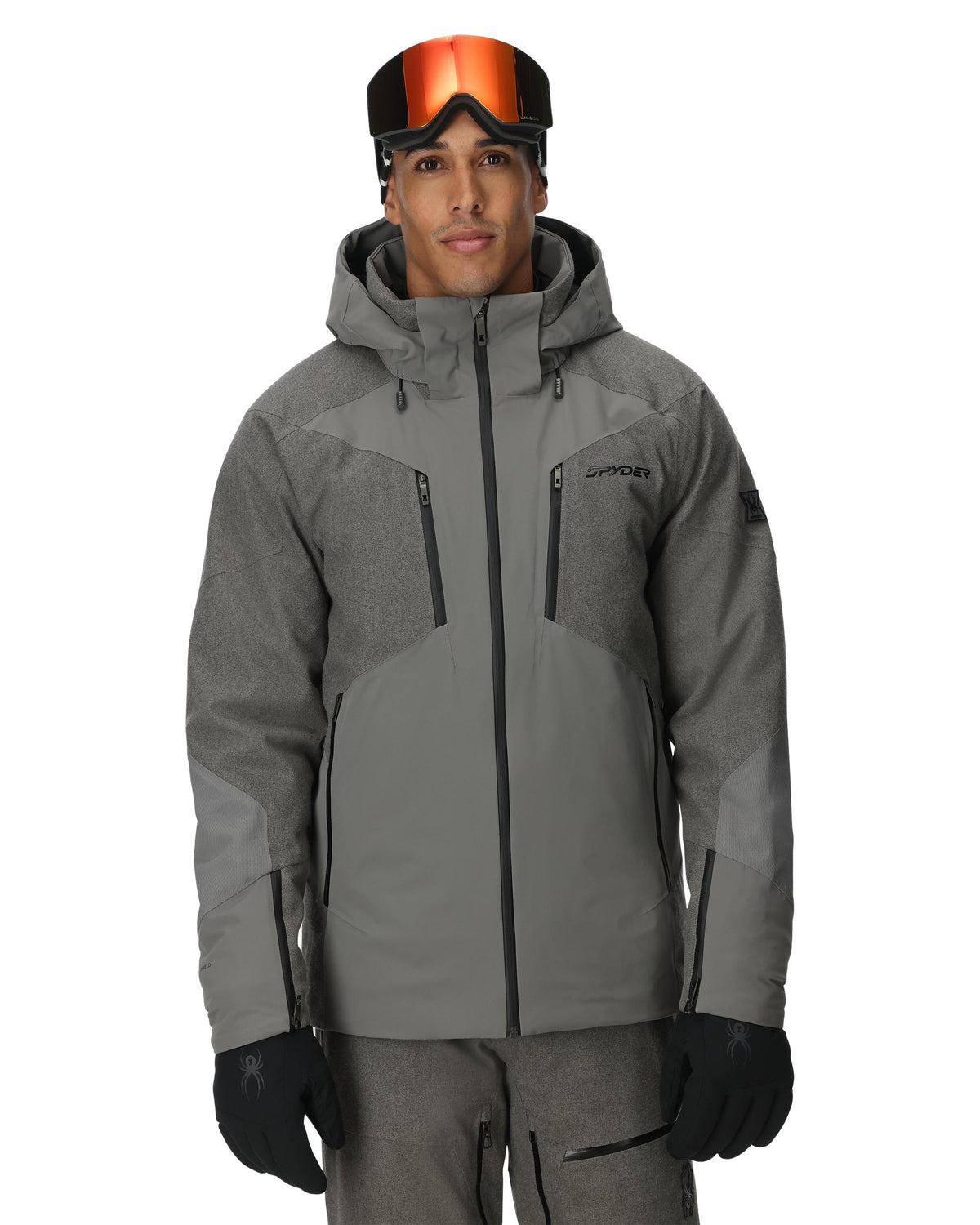 Person wearing a gray ski jacket with goggles on a white background