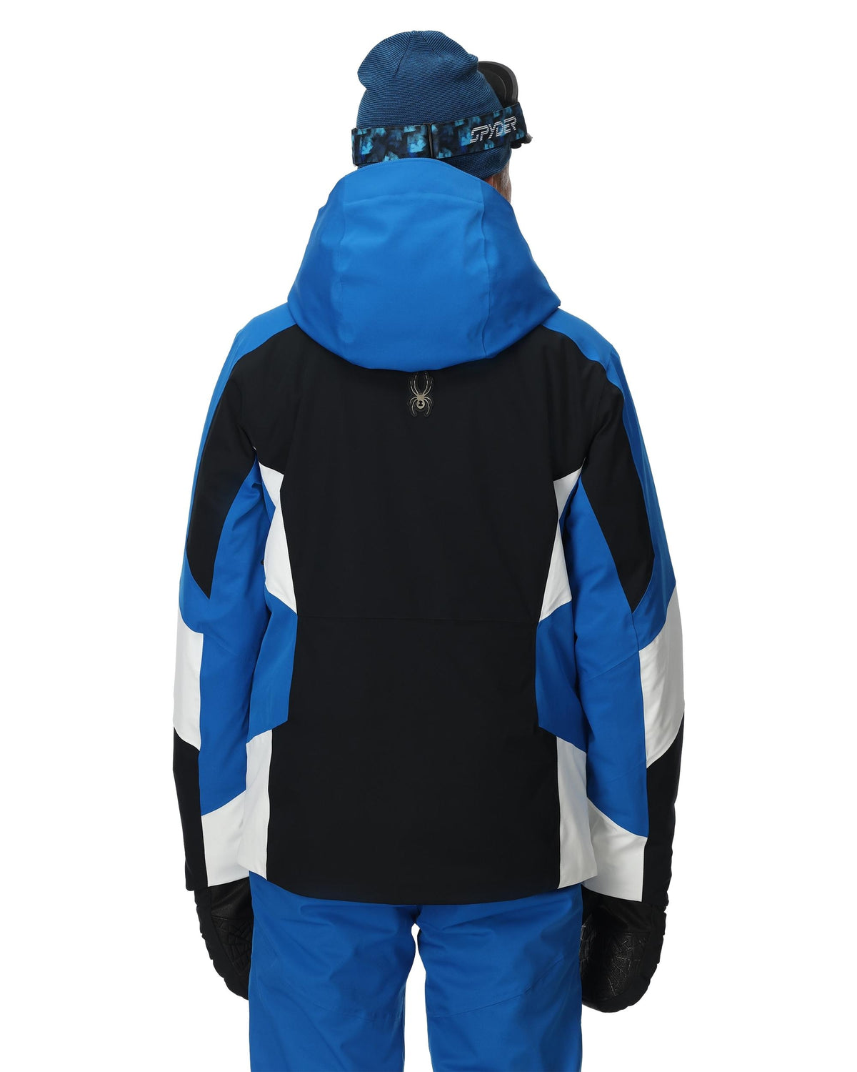 Person wearing a blue and black jacket with white accents on a white background