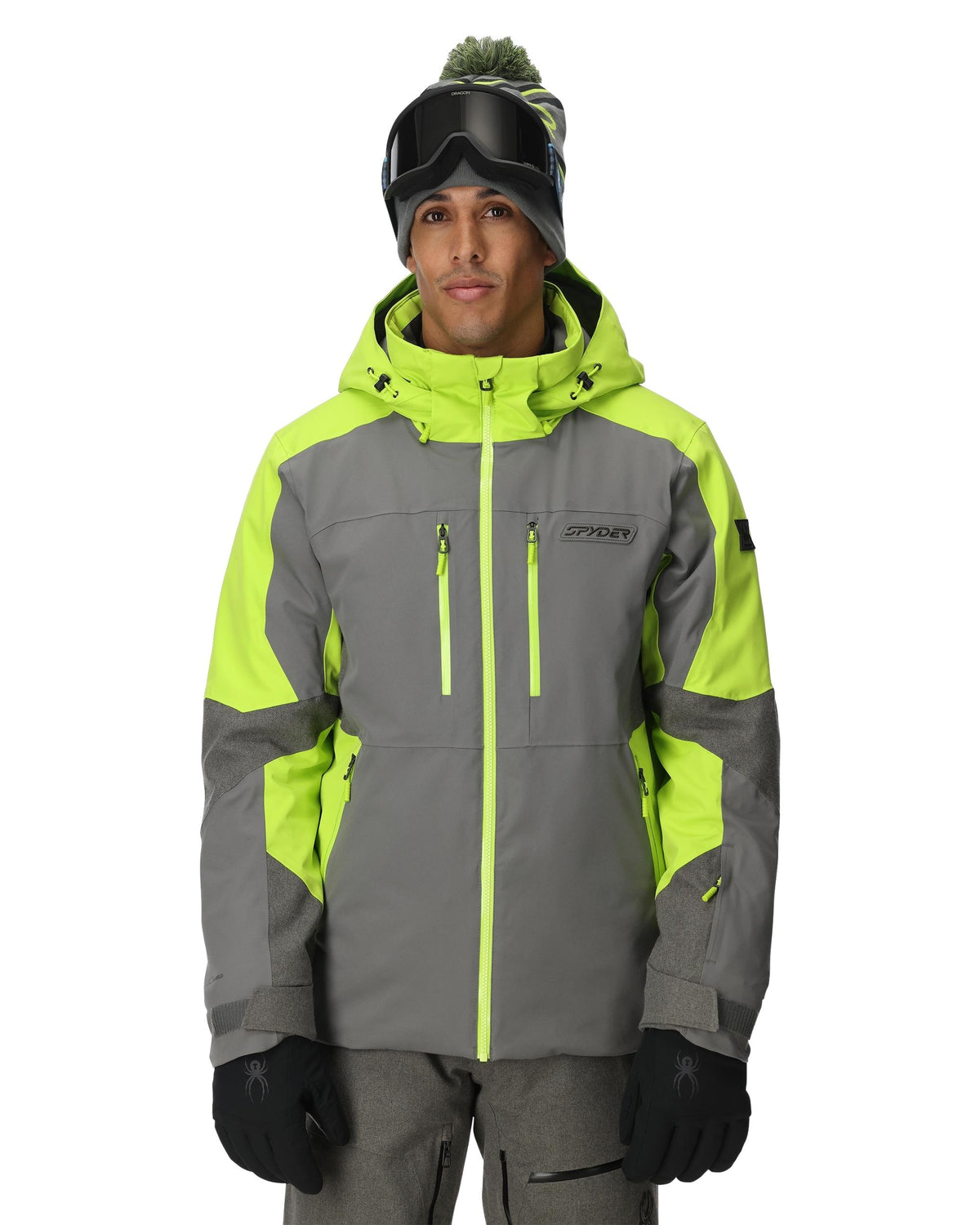 Person wearing a gray and green ski jacket with goggles on a white background