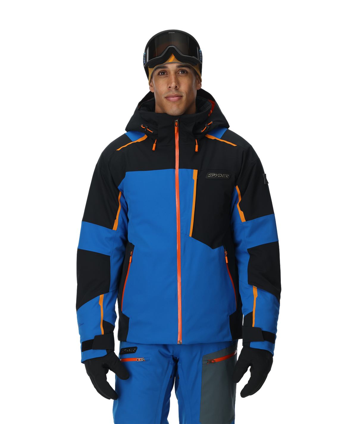Person wearing a blue and black ski jacket with orange accents on a white background