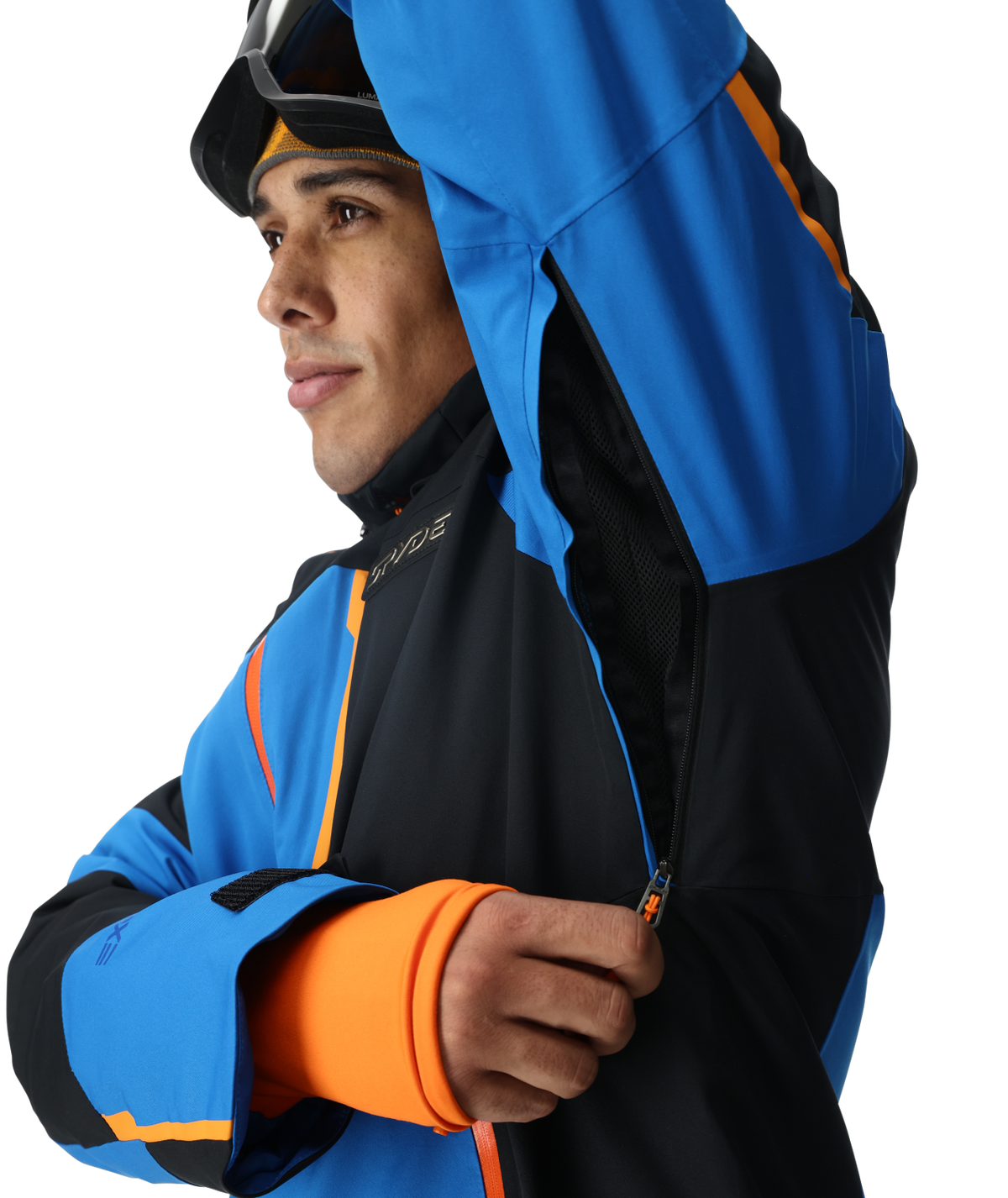 Person wearing a blue and black jacket with orange accents on a white background