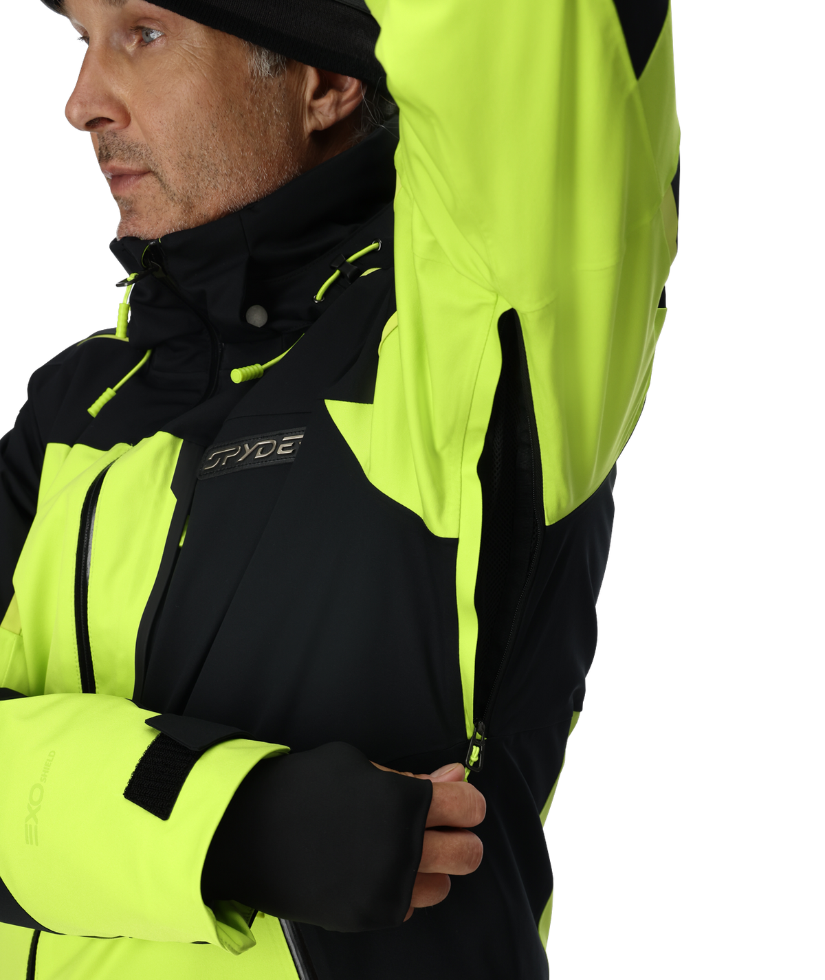 Person wearing a black and yellow jacket with 'Exped' branding on a white background