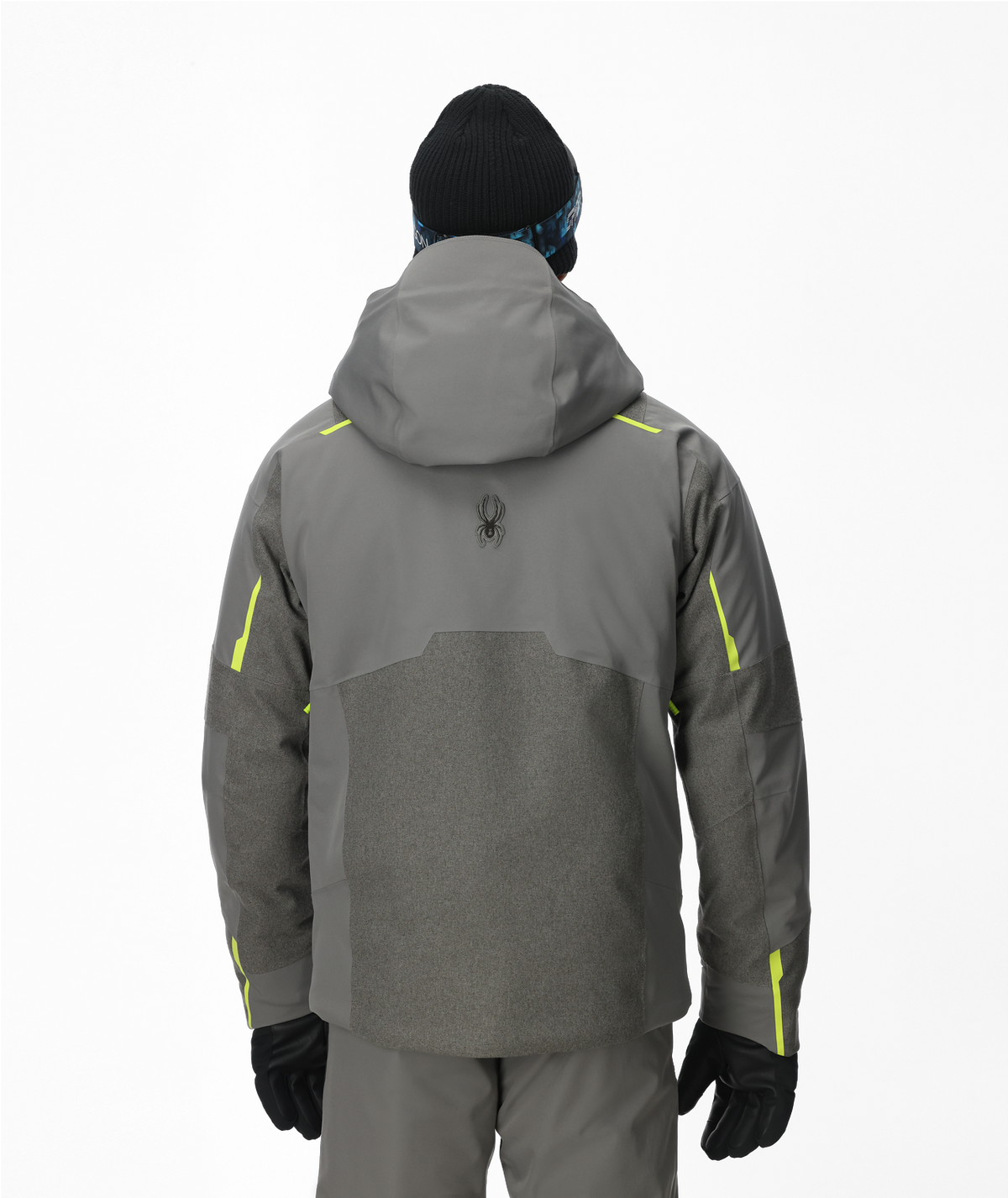 Person wearing a gray jacket with yellow accents on a white background