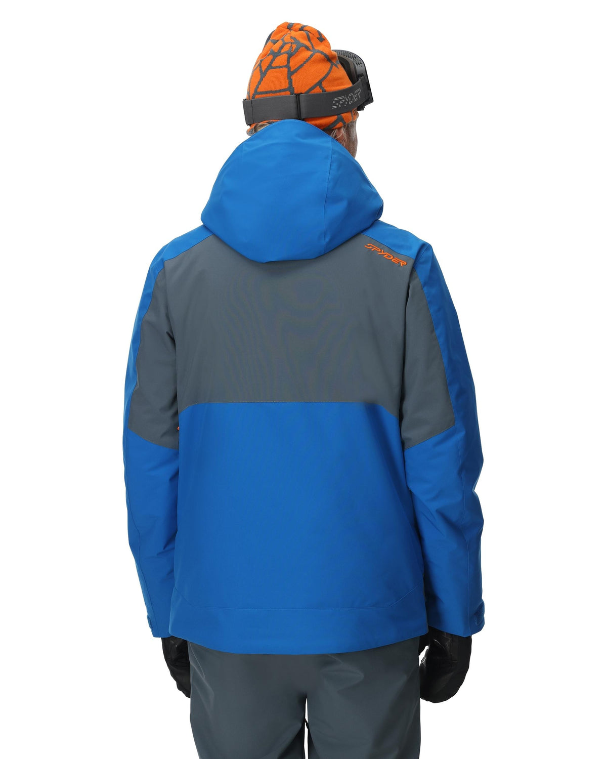 Person wearing a blue and gray jacket with a visible brand logo on a white background