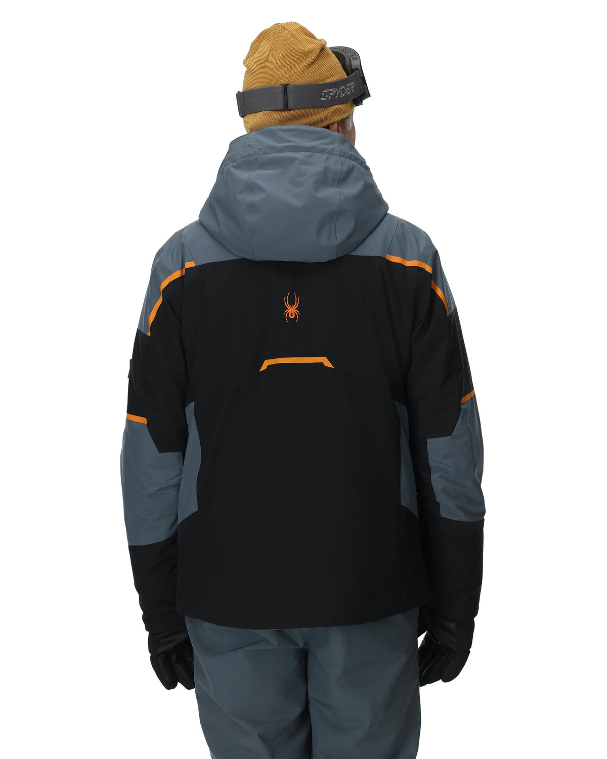 Person wearing a black and gray jacket with orange accents on a white background