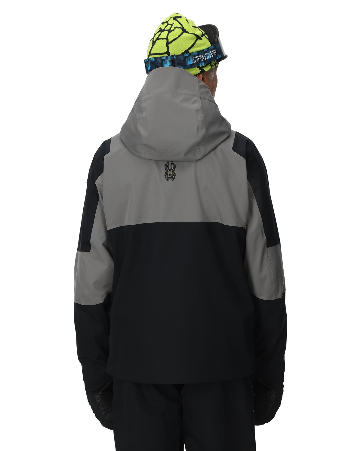 Person wearing a black and gray jacket with a hood on a white background