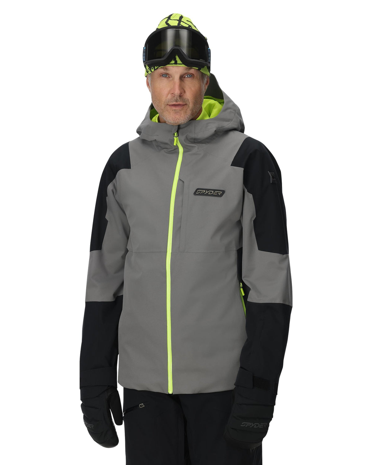 Person wearing a gray and black jacket with neon green accents on a white background