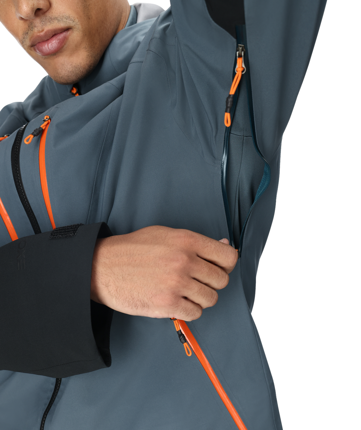 Person wearing a gray jacket with orange zippers on a white background