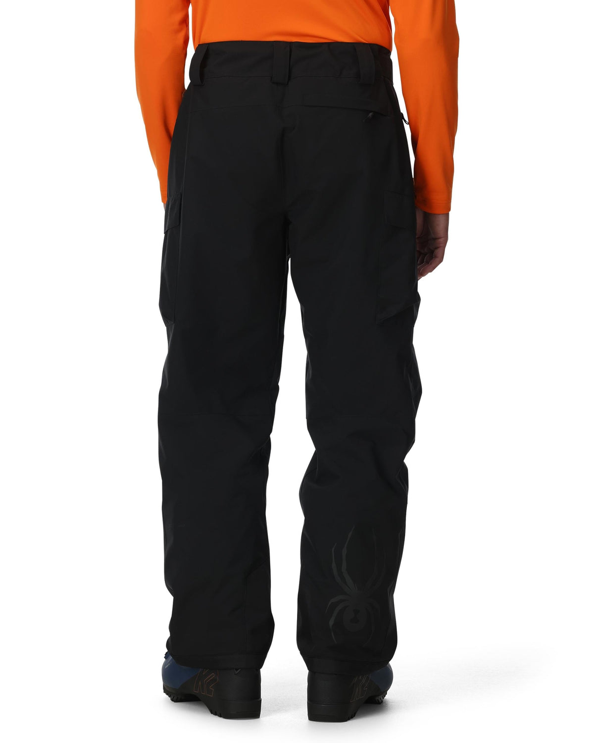 Black pants worn by a person with an orange top on a white background