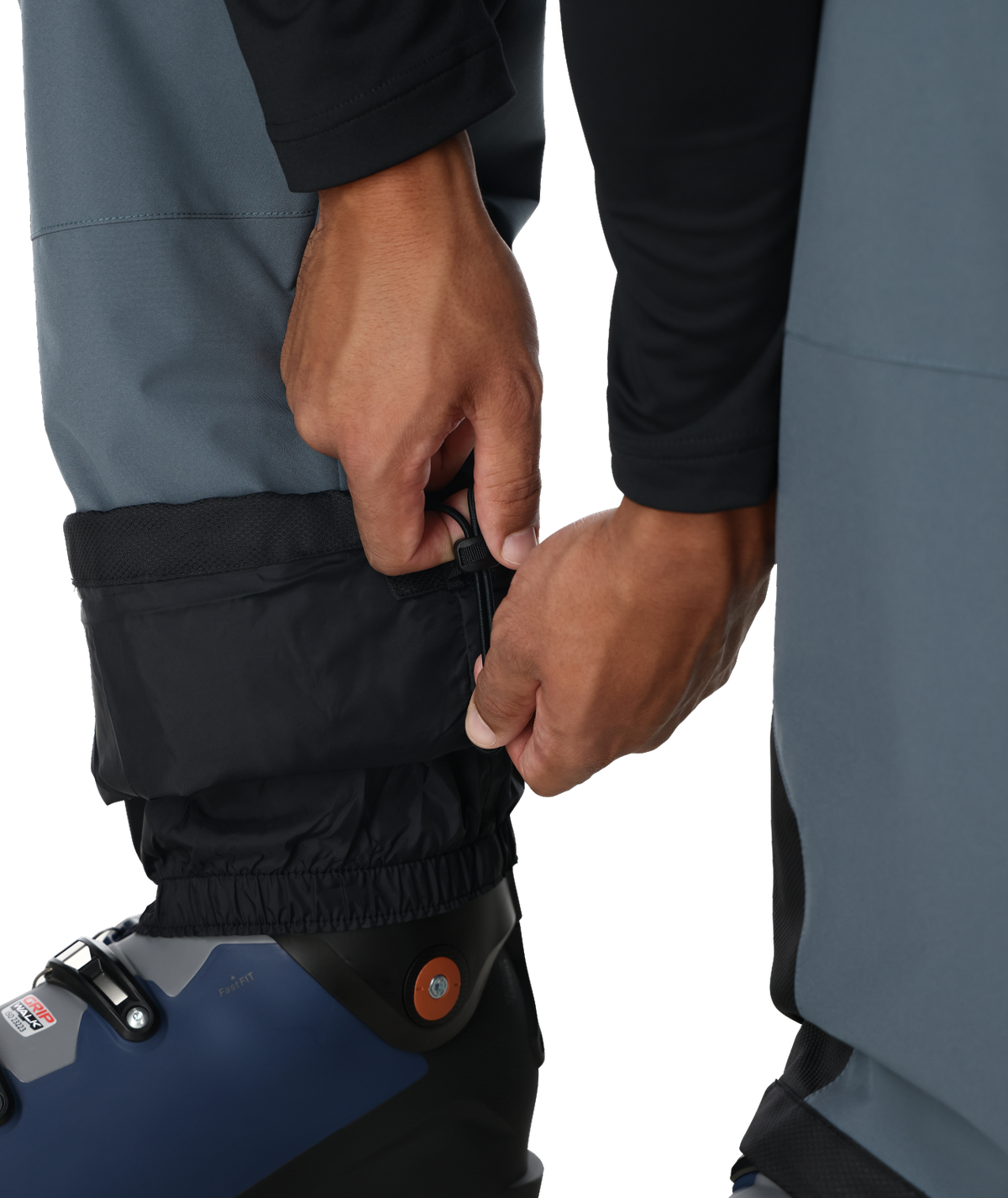 Person adjusting a blue and black boot with a white background