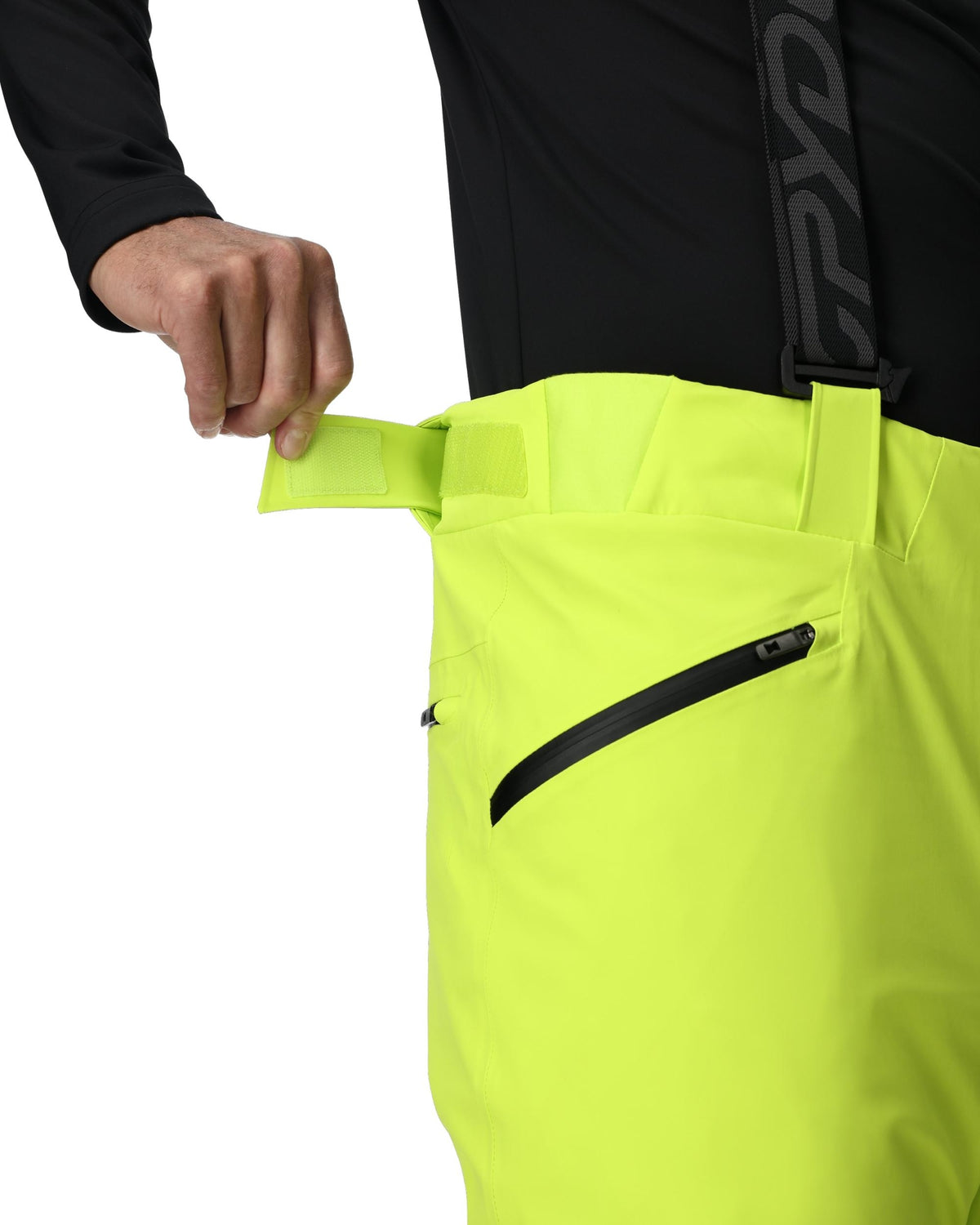Person wearing bright yellow pants with a black zipper, on a white background