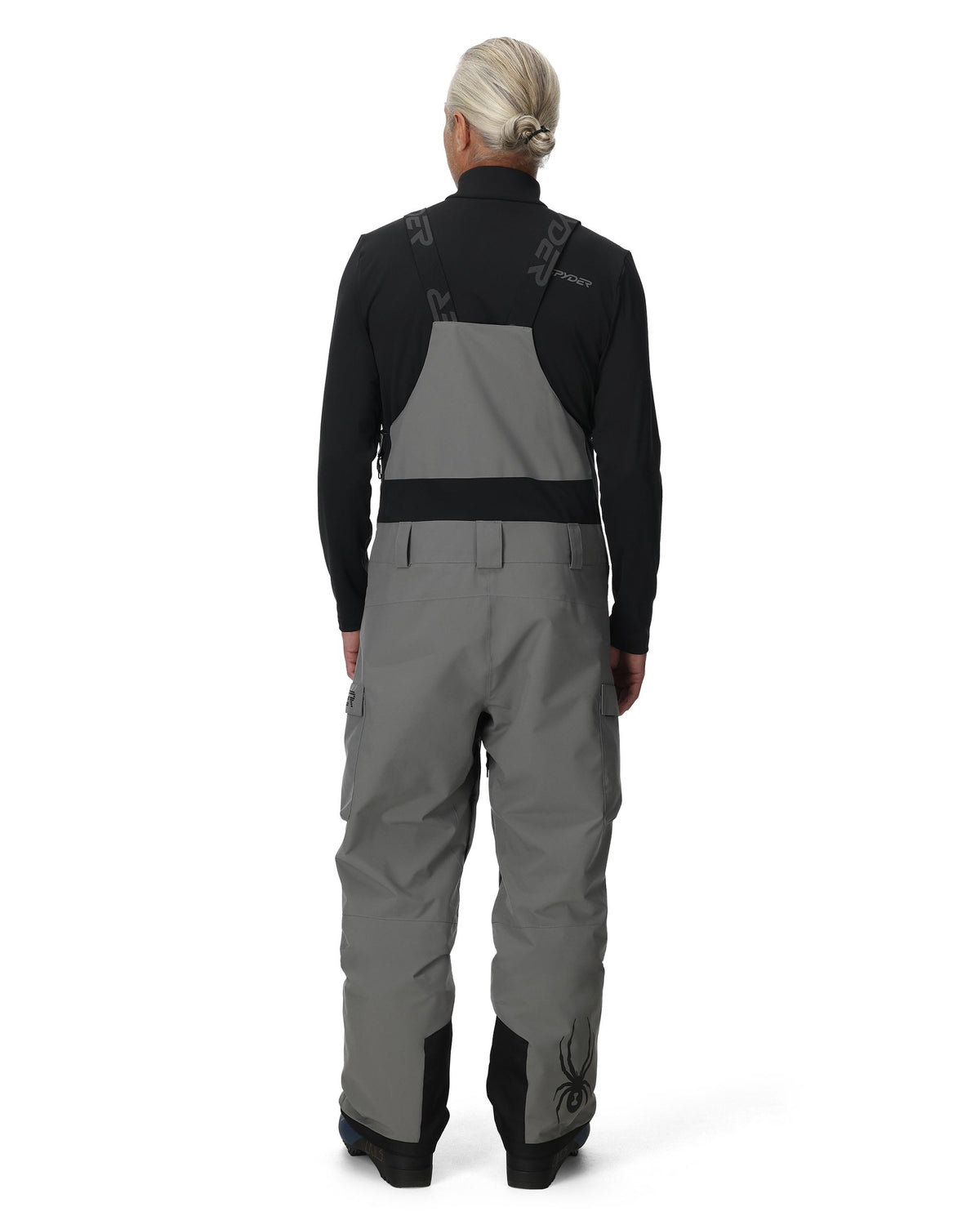 Person wearing a gray and black snowmobile suit on a white background