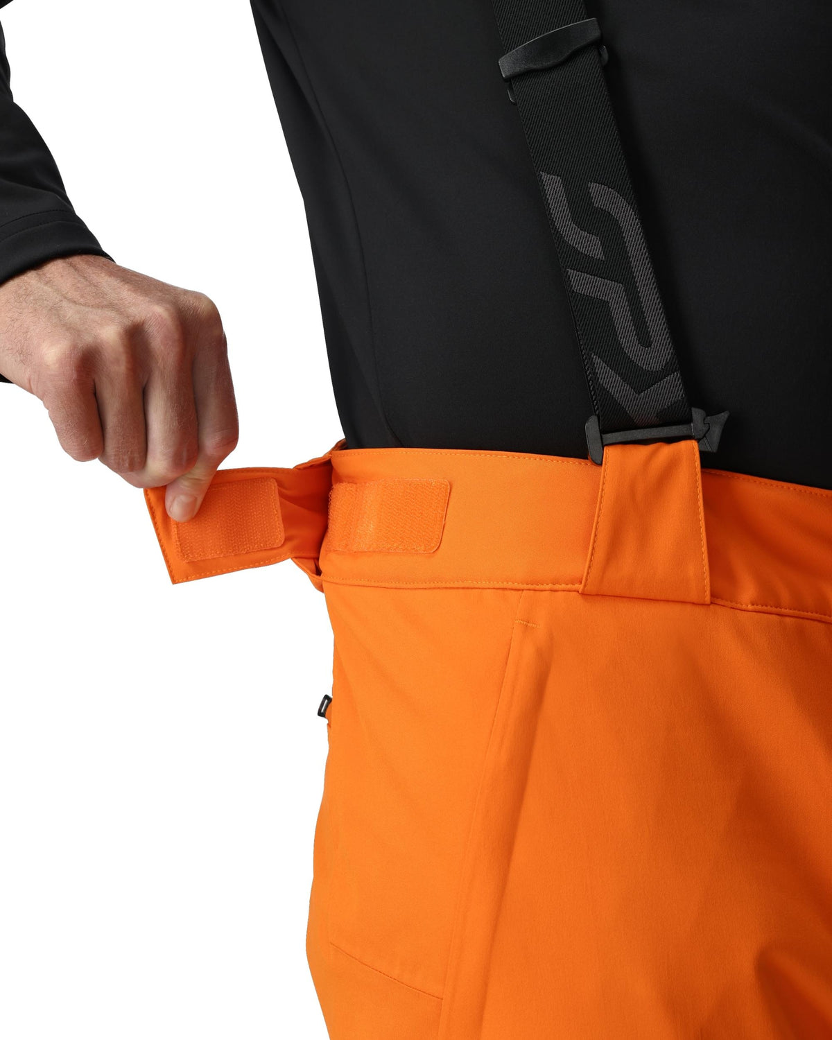 Close-up of orange pants with a black jacket featuring a logo on a white background