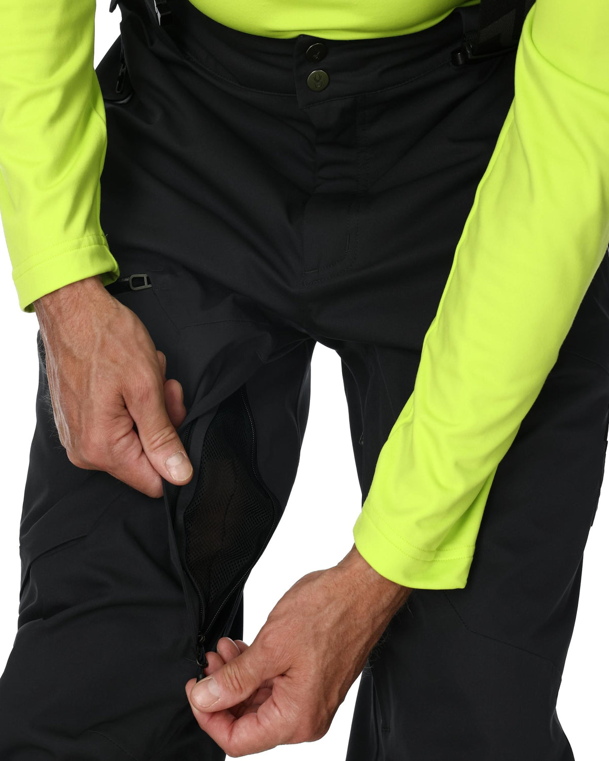Person wearing black pants with a bright yellow jacket on a white background