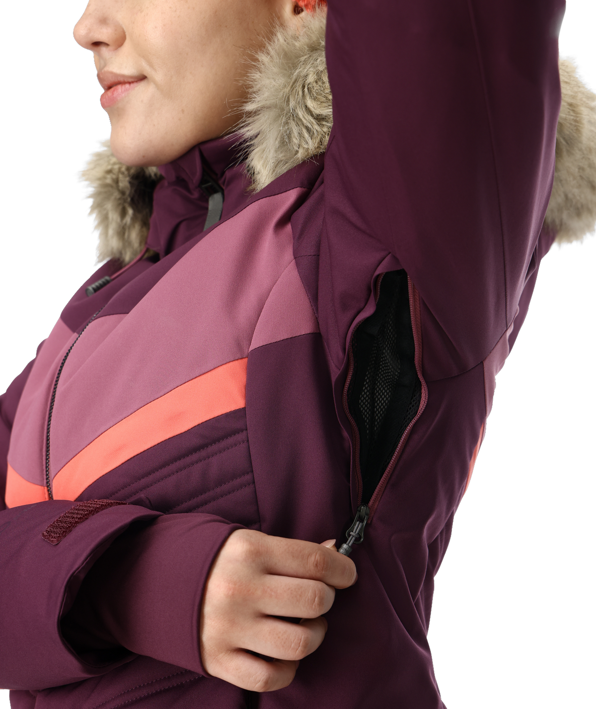 Close-up of a person wearing a purple winter jacket with fur hood on a white background