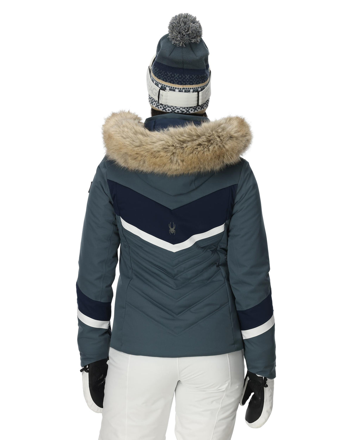 Blue winter jacket with fur hood and white pants on a white background