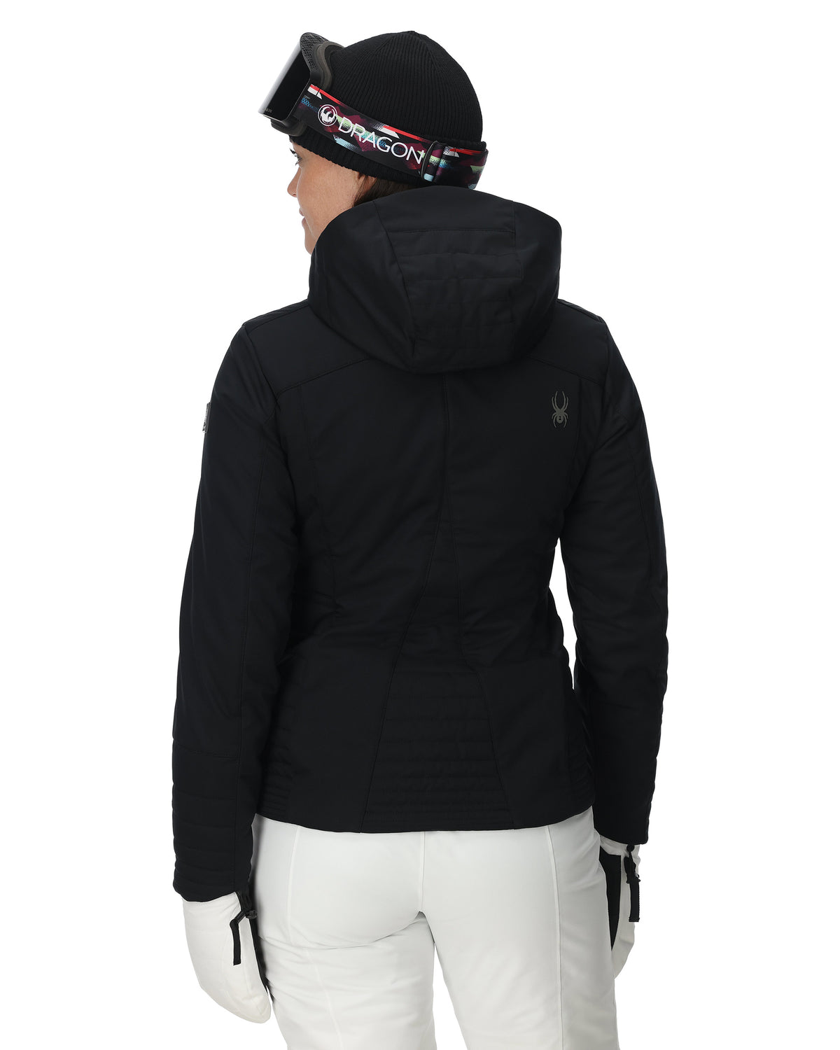 Person wearing a black jacket and white pants with a helmet on a white background