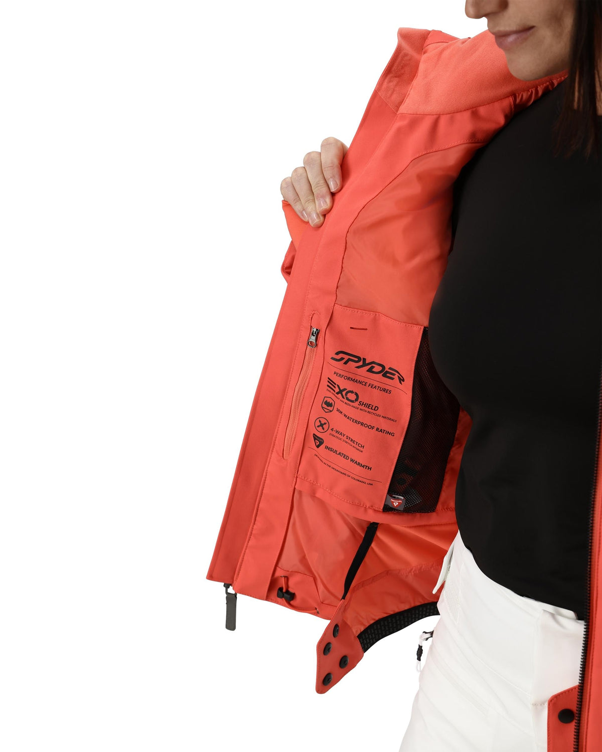 Person wearing a red Spyder jacket with a white background