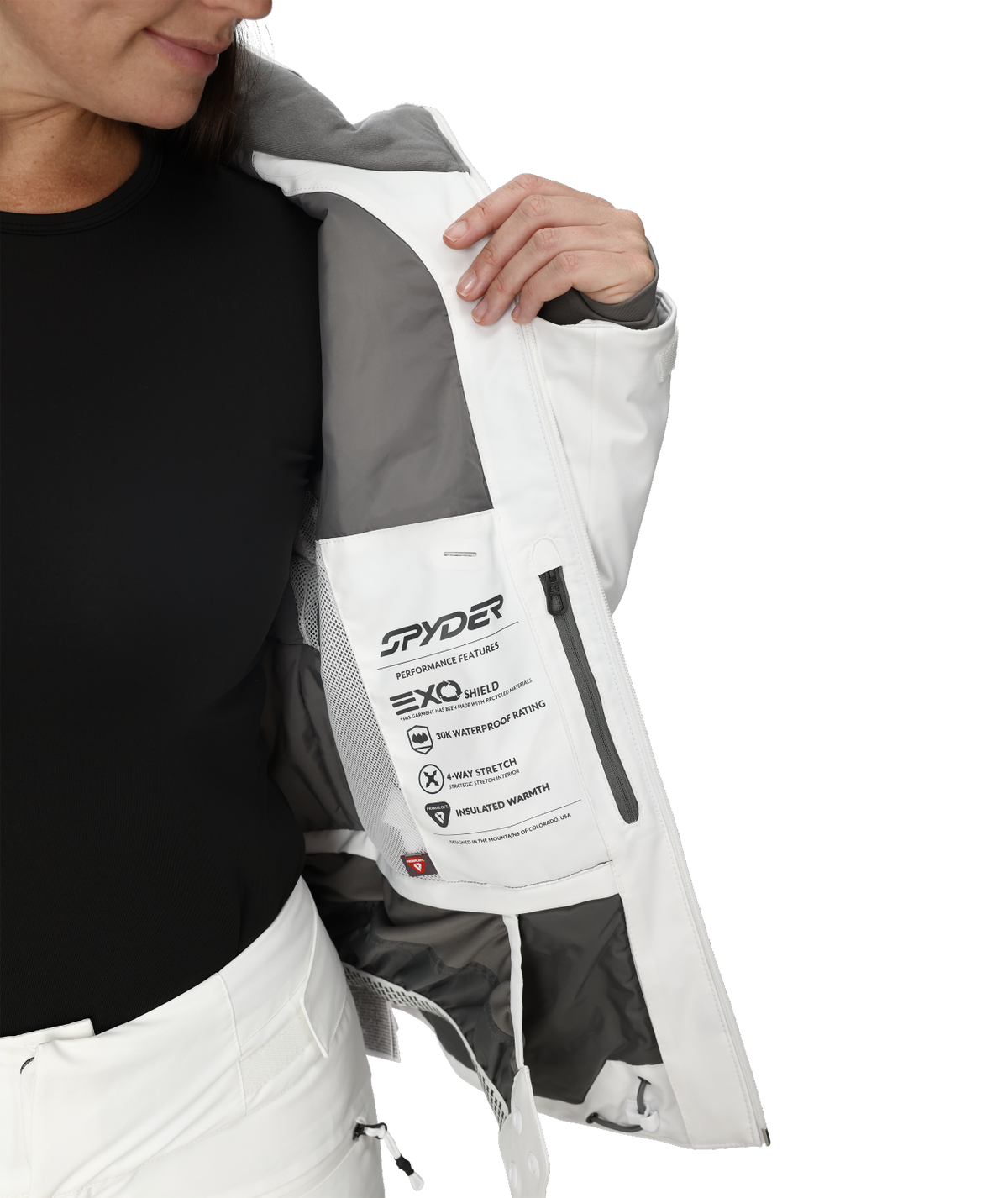 Person wearing a white and gray jacket with Spyder branding on a white background