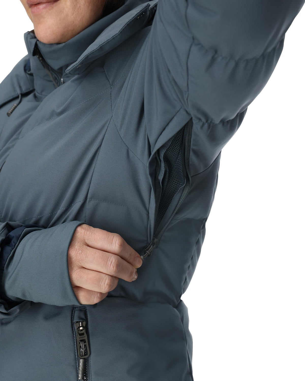 Close-up of a person wearing a dark blue insulated jacket on a white background