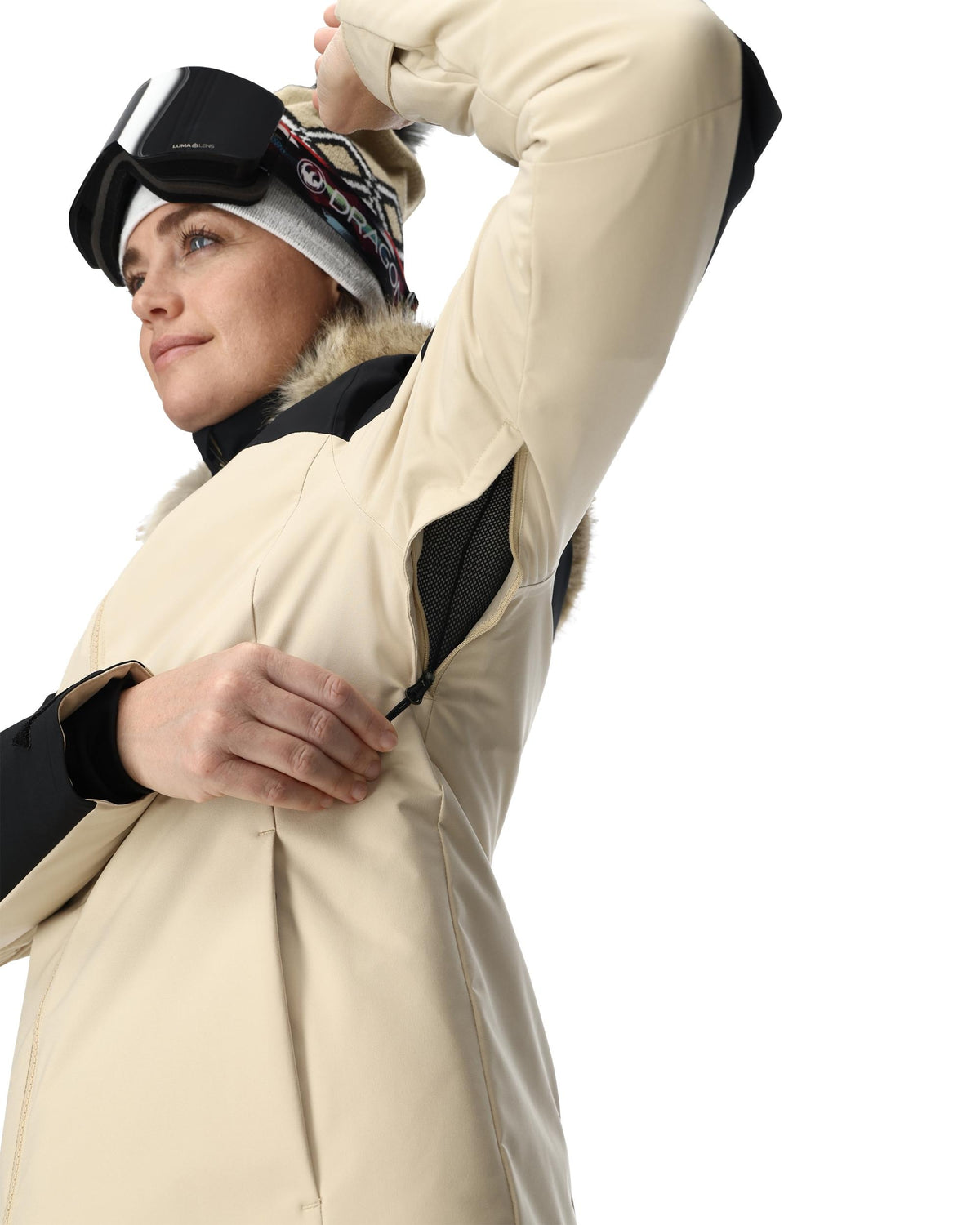 Person wearing a beige winter coat with black accents on a white background