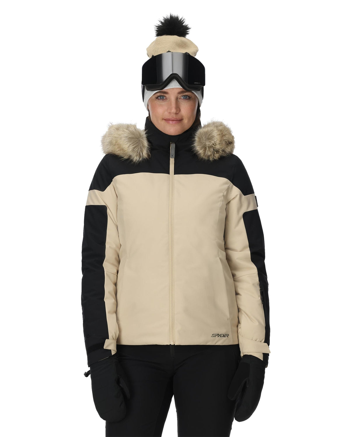 Person wearing a black and beige winter jacket with fur-lined hood on a white background