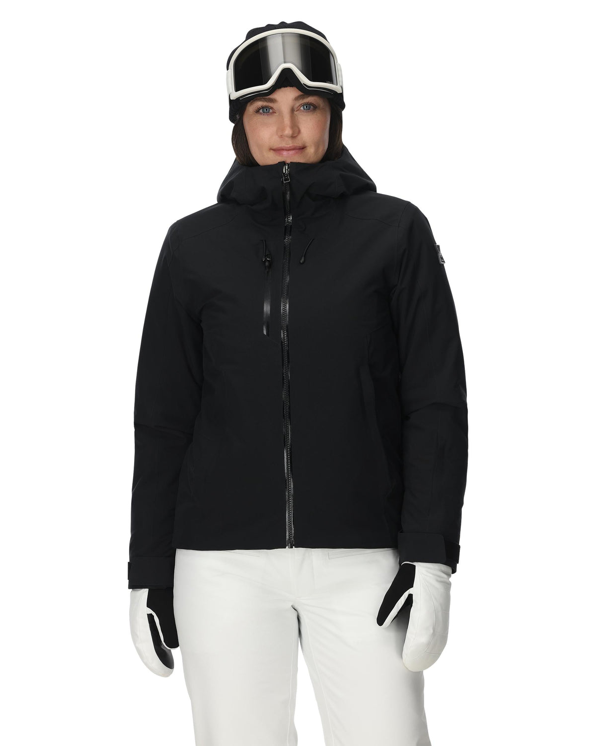 Person wearing a black jacket and white pants with goggles on a white background