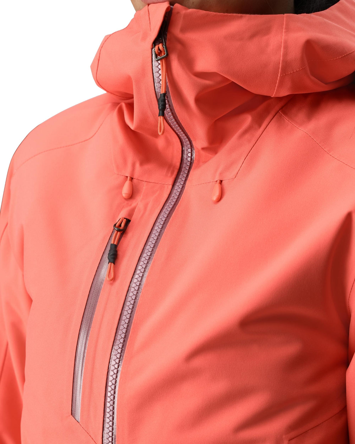 Close-up of a coral-colored jacket with a zipper on a white background