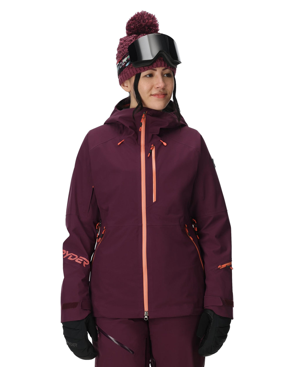 Person wearing a maroon ski jacket with orange accents on a white background