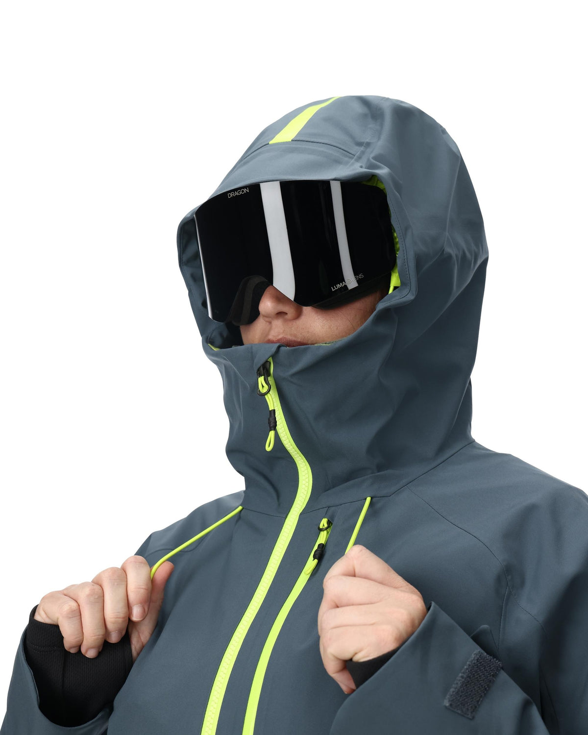 Person wearing a gray hooded jacket with neon accents and goggles on a white background