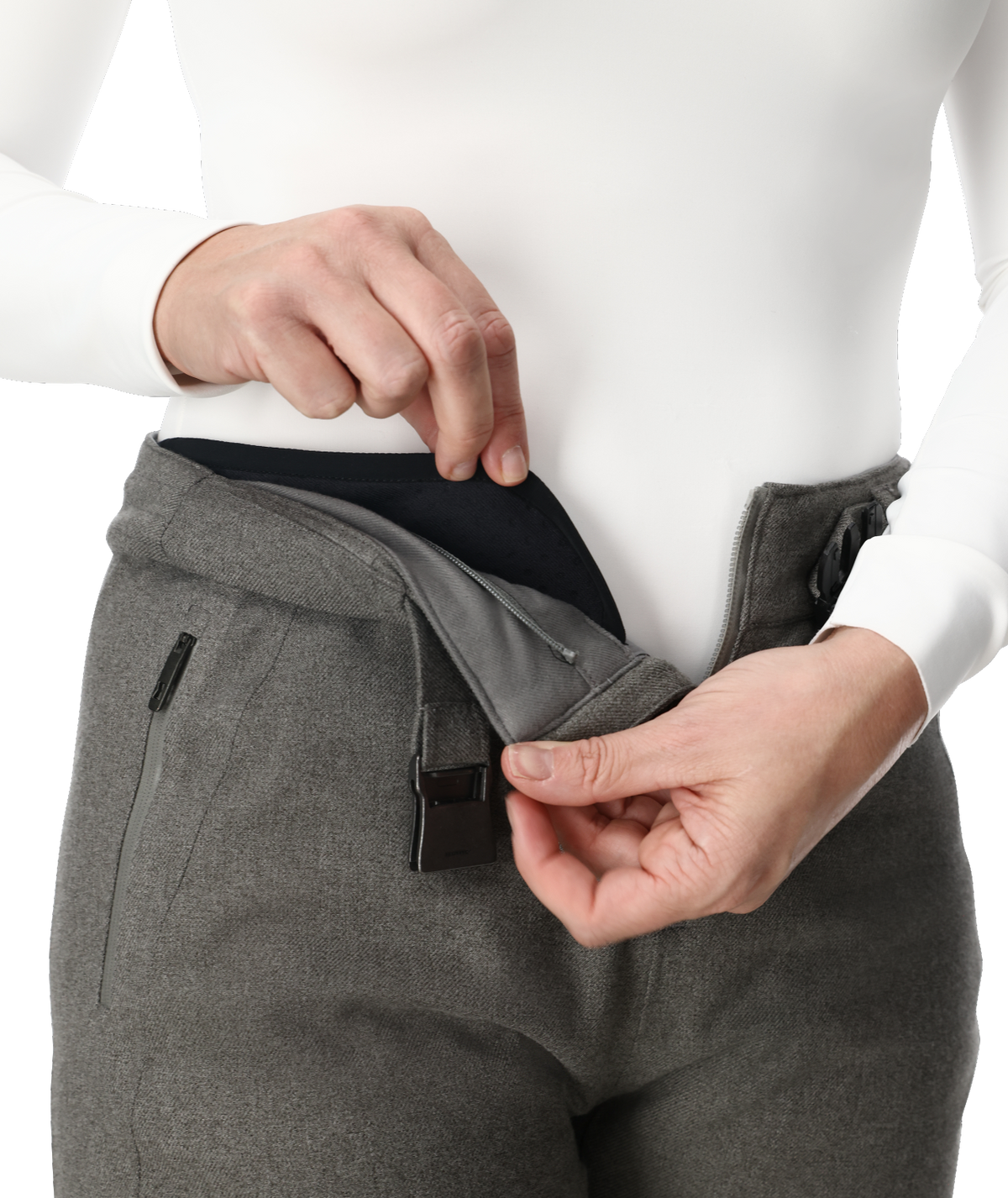 Person wearing gray pants with a white shirt, focusing on the waist area.