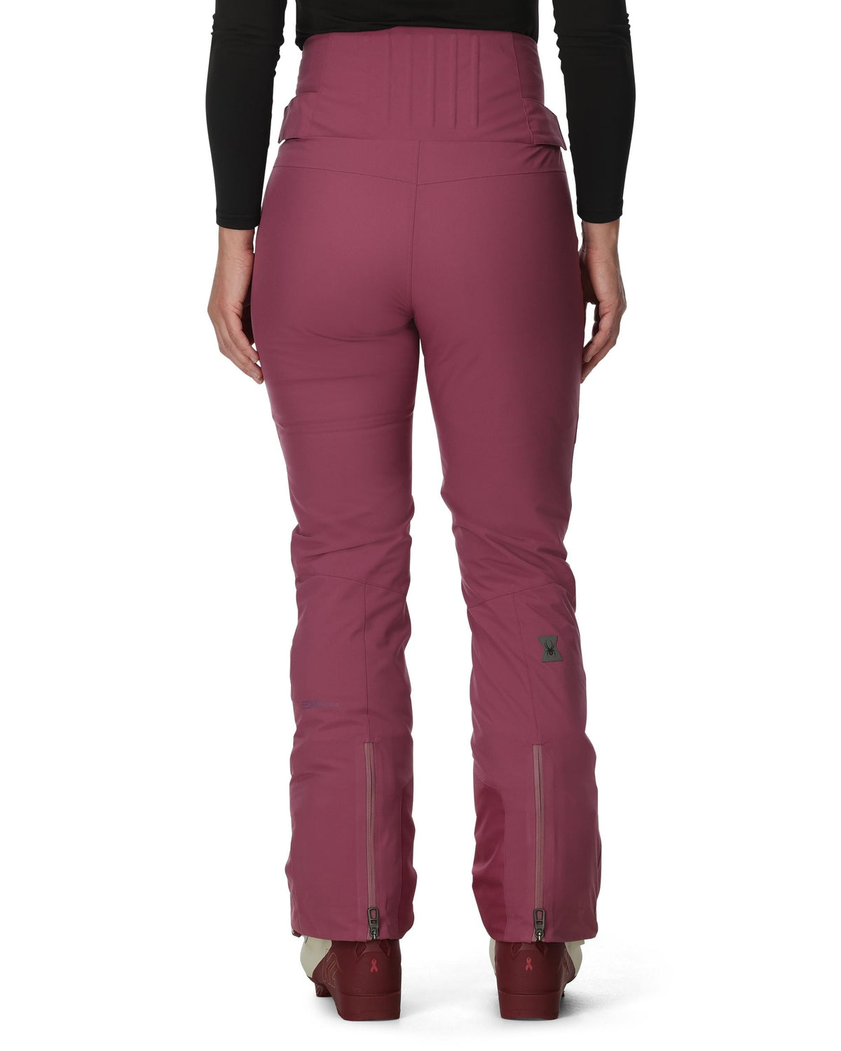 Maroon ski pants worn by a person on a white background