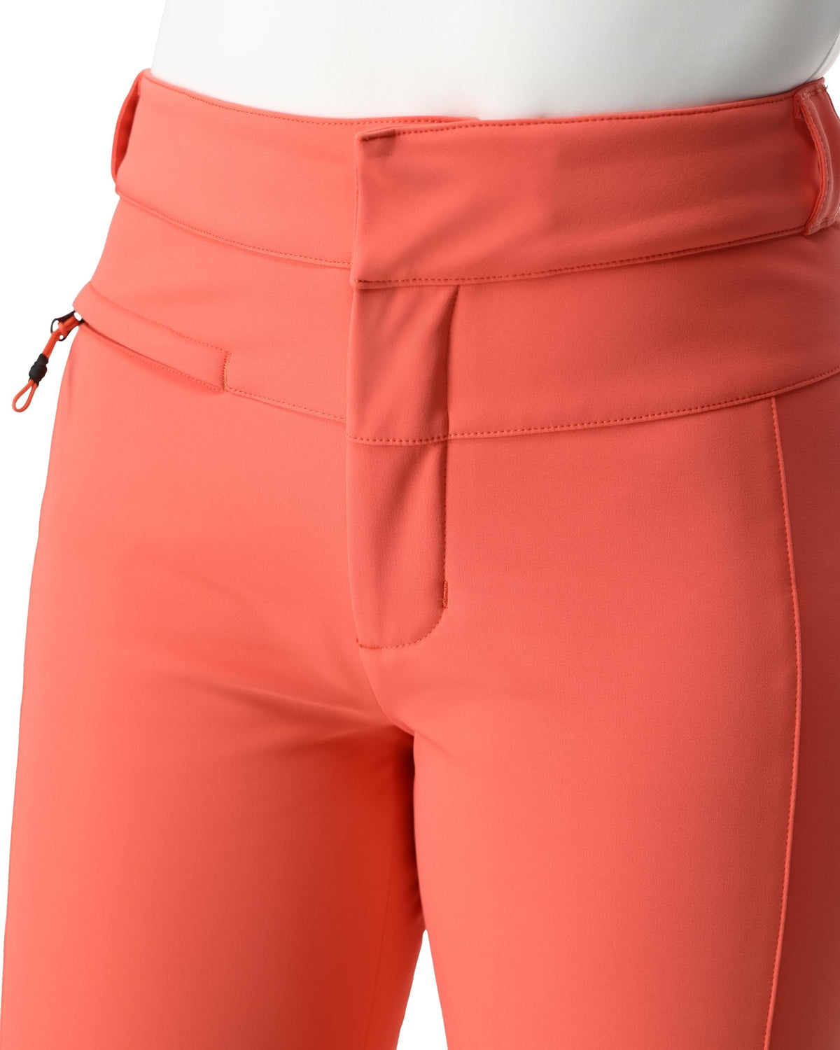 Close-up of coral-colored pants with a pocket and zipper detail on a white background