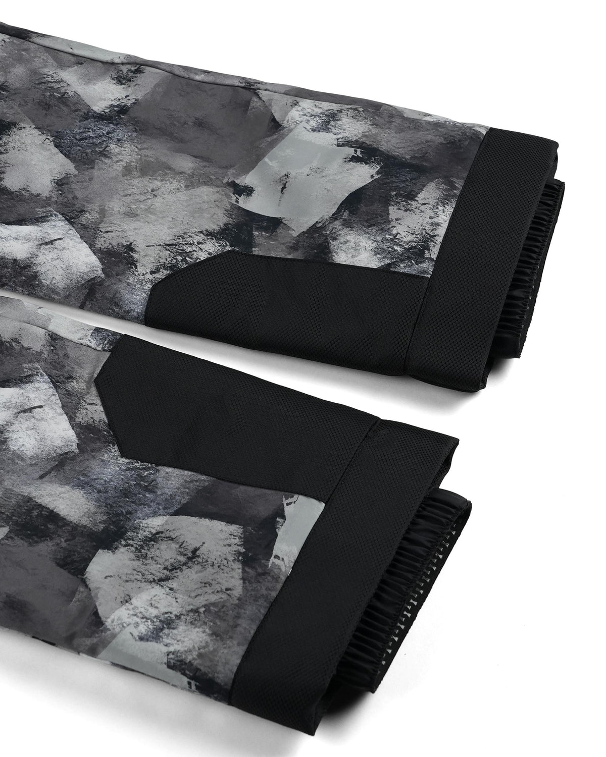 Black and gray patterned blanket with textured surface on a white background
