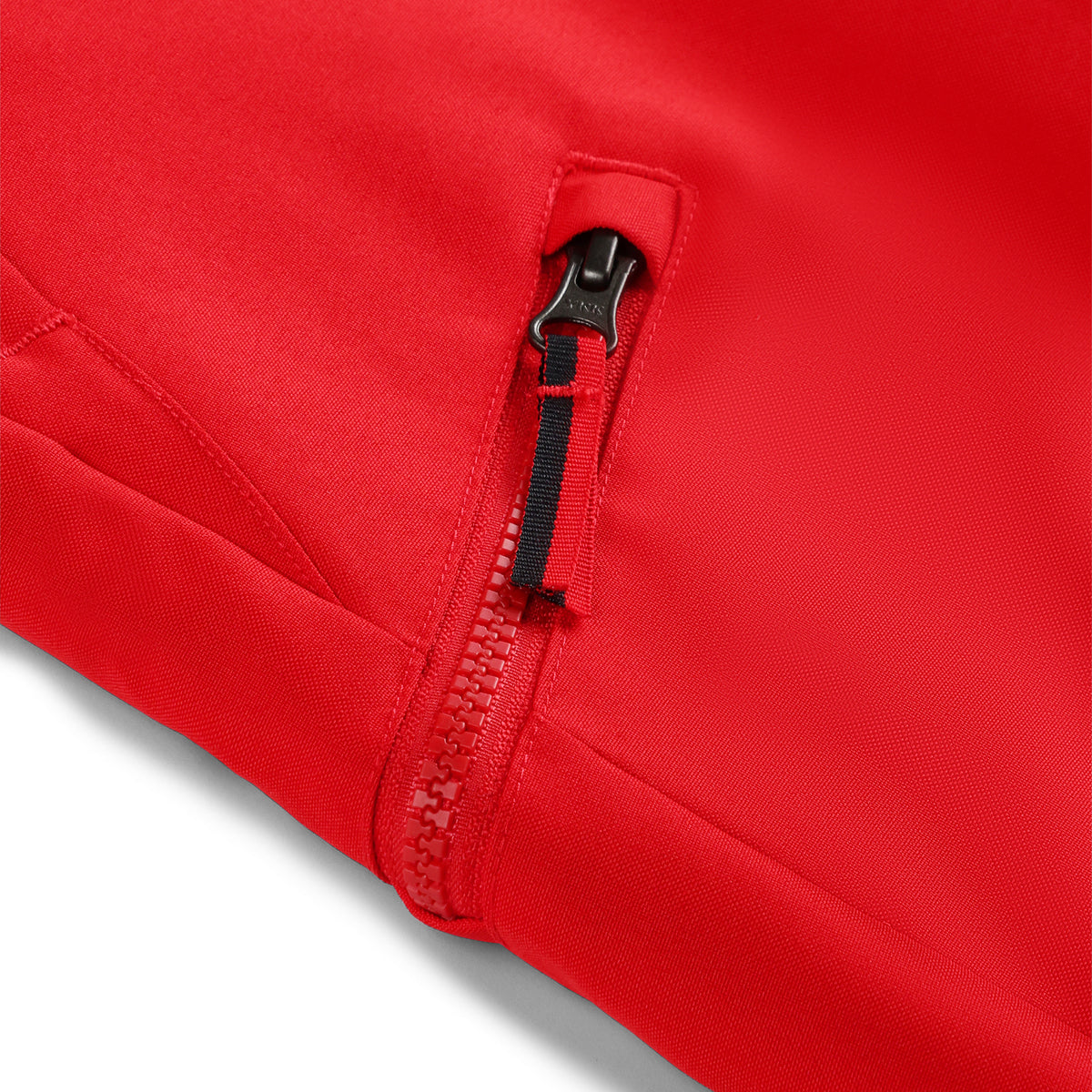 Red ski pants with adjustable suspenders and zippered hand pockets.