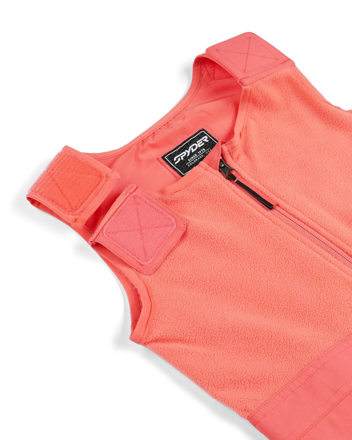 Close-up of a pink fleece vest with a brand logo on a white background