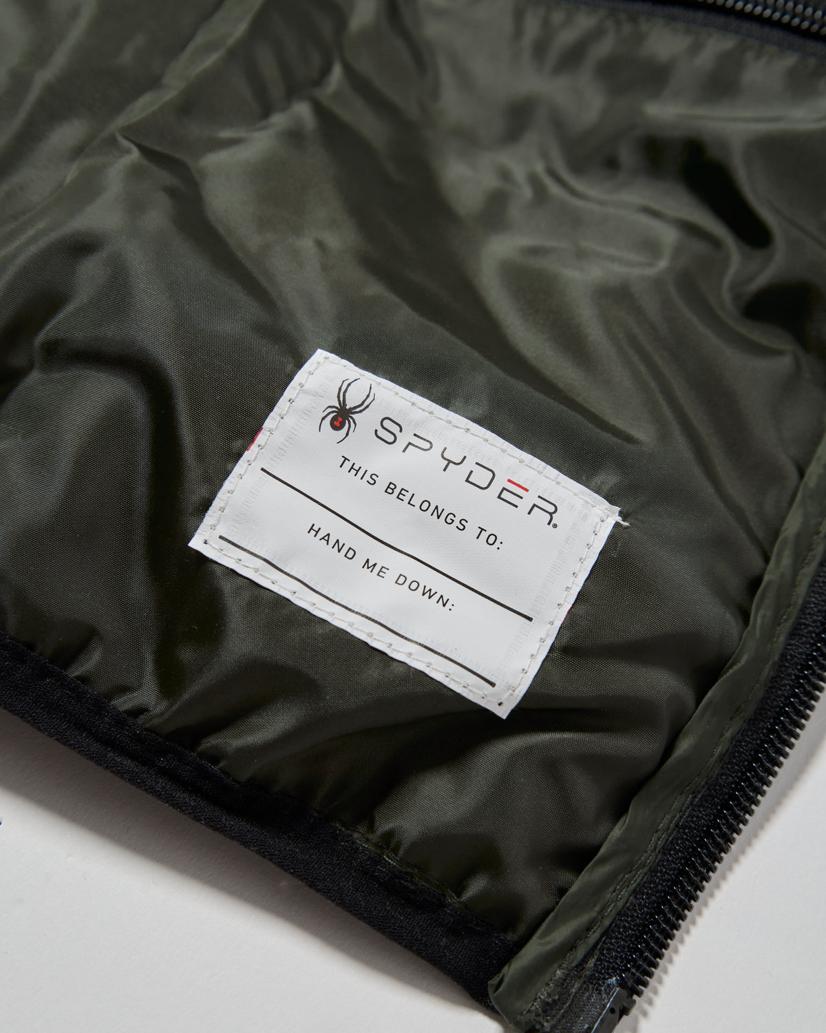 Spyder label on a green fabric background