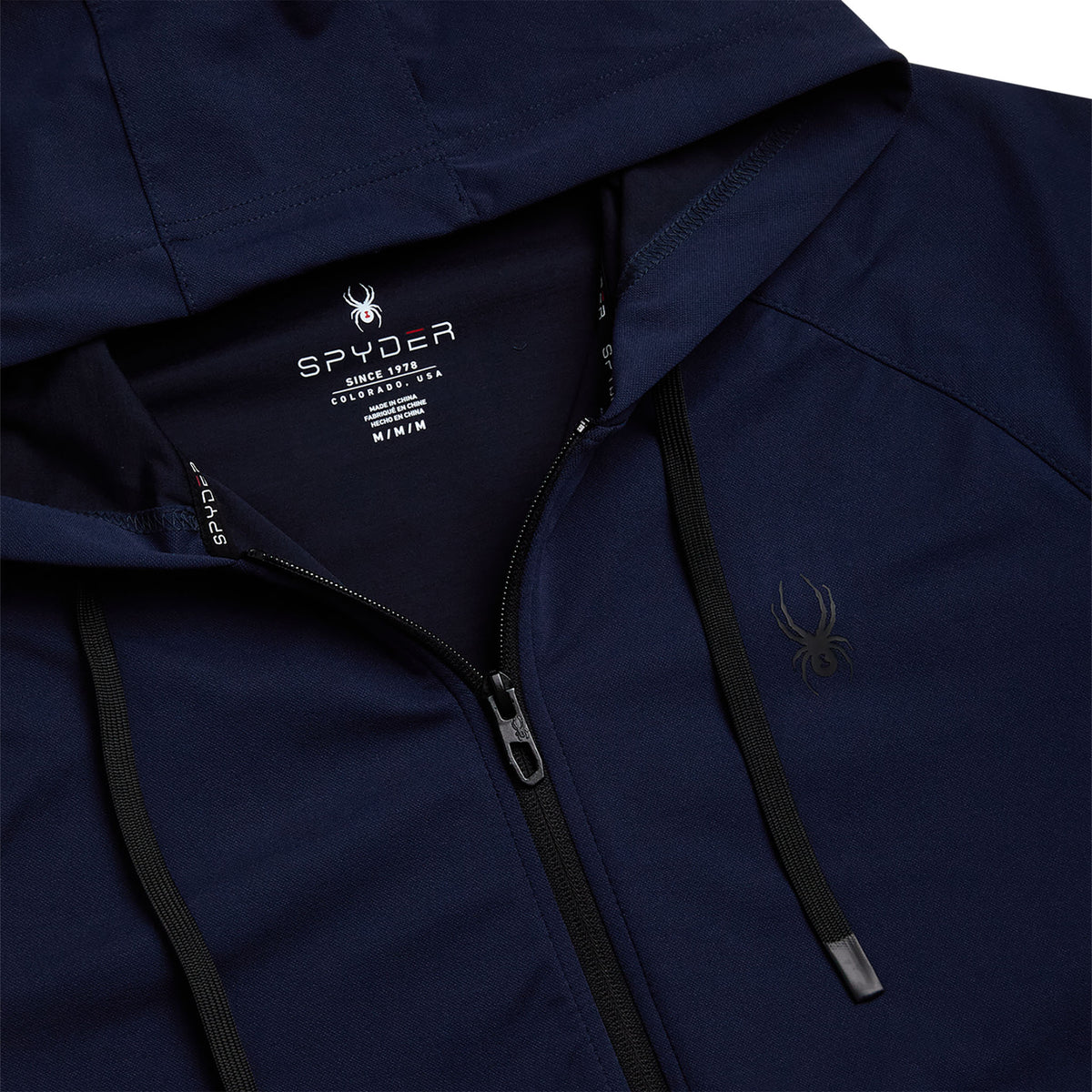 Close-up of a navy blue Spyder jacket with brand logo and text.